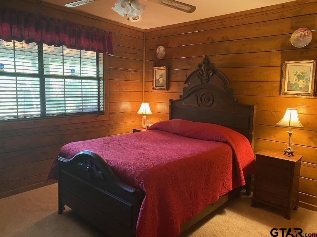 1765 Crabapple Road Gilmer, TX 75645 - Photo 9 of 29 a bedroom with a bed and wooden floor