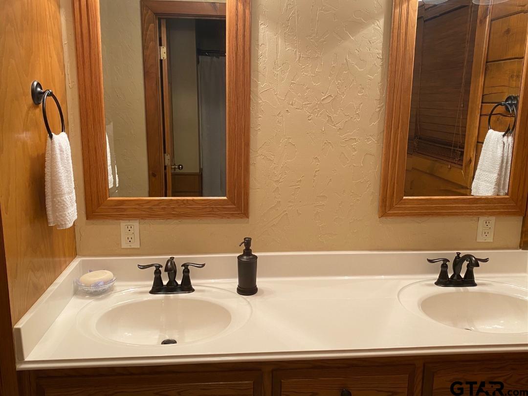 1765 Crabapple Road Gilmer, TX 75645 - Photo 10 of 29 a bathroom with a sink and a mirror