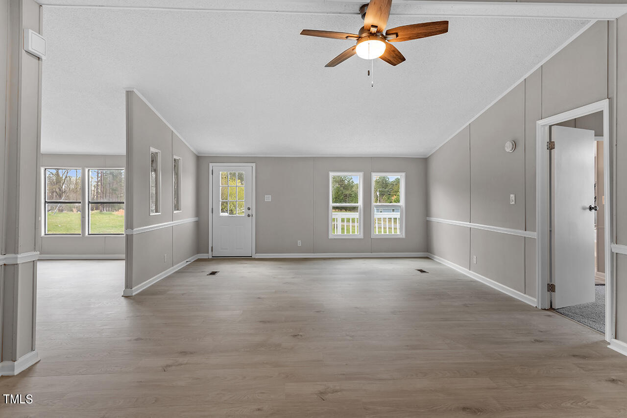858 Foster Road Henderson, NC 27537 - Photo 14 of 38 wooden floor in an empty room with a window