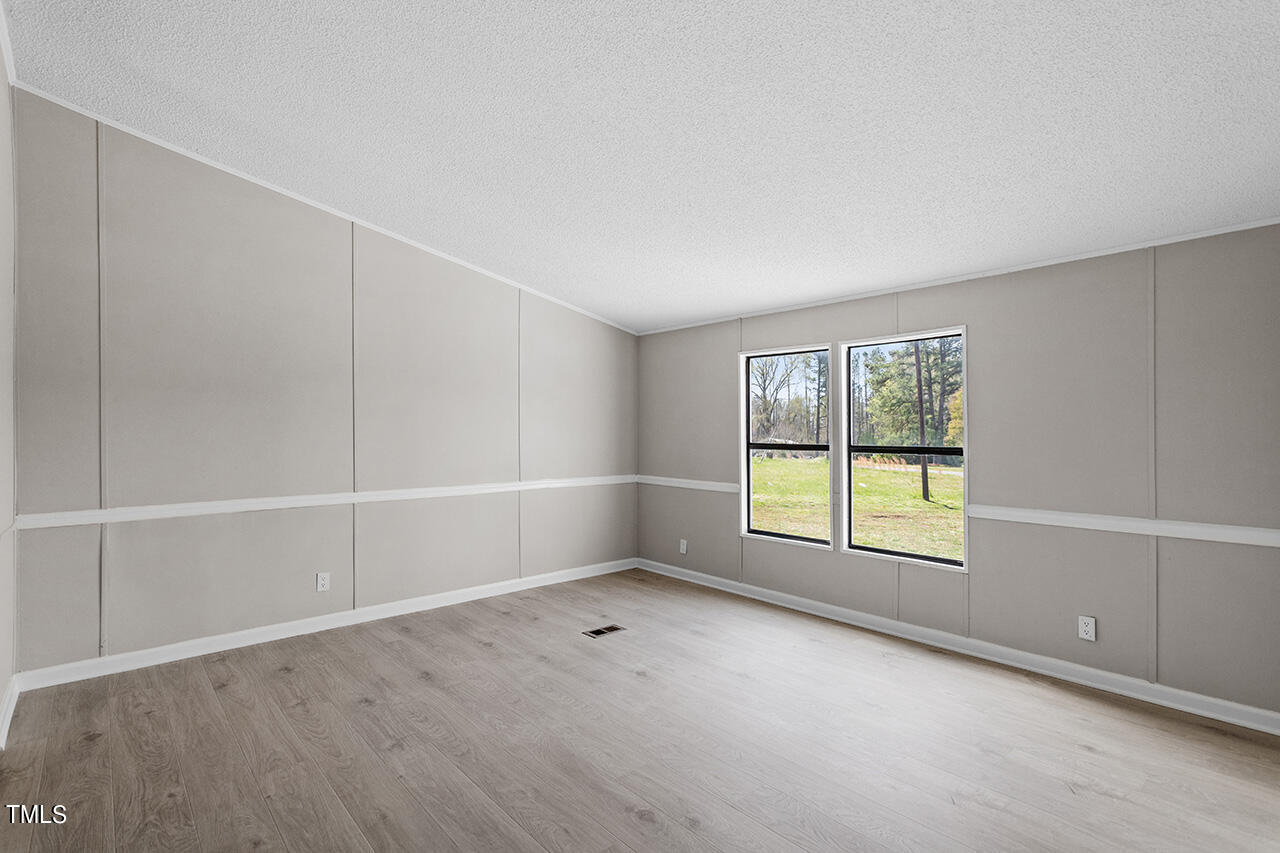 858 Foster Road Henderson, NC 27537 - Photo 20 of 38 an empty room with a window