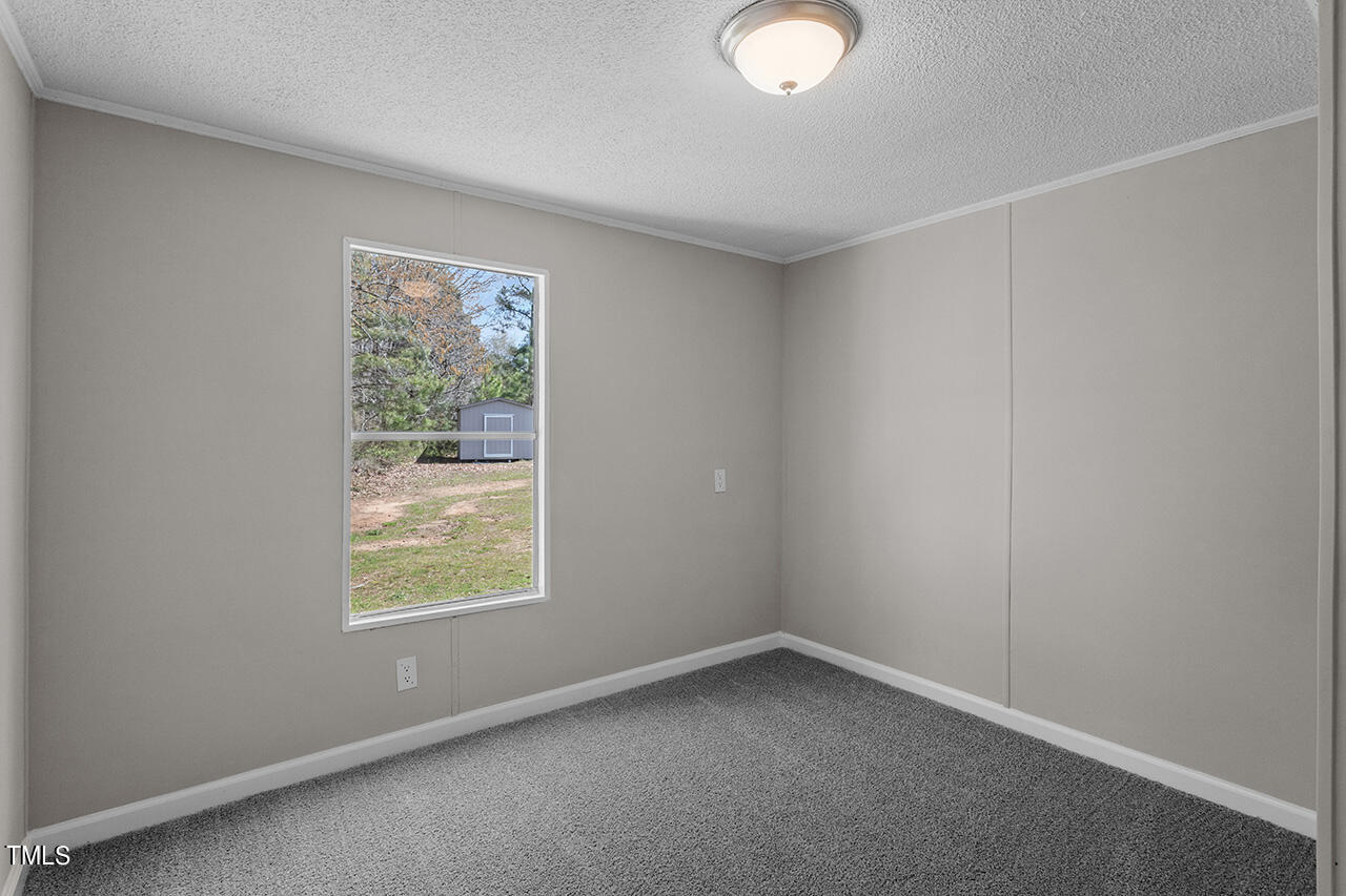 858 Foster Road Henderson, NC 27537 - Photo 22 of 38 an empty room with a window
