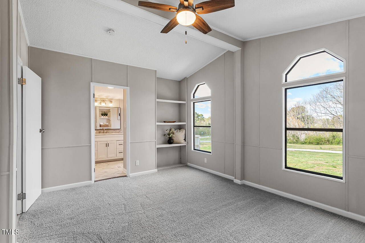 858 Foster Road Henderson, NC 27537 - Photo 23 of 38 a view of an empty room with a window