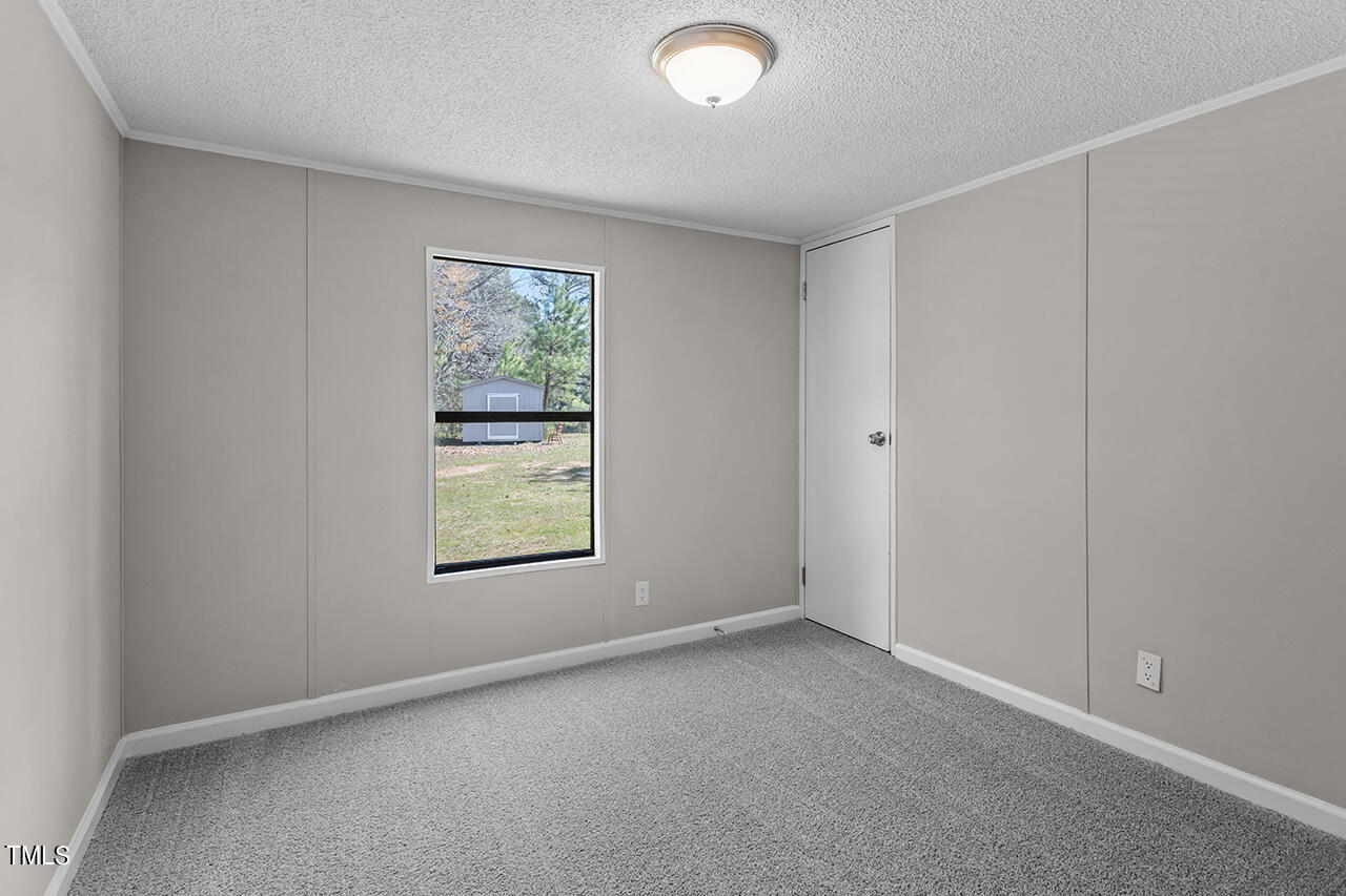 858 Foster Road Henderson, NC 27537 - Photo 26 of 38 an empty room with a window
