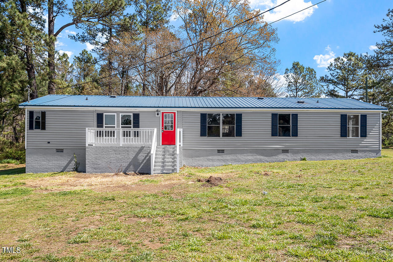 858 Foster Road Henderson, NC 27537 - Photo 3 of 38 a house view with swimming pool in front of it