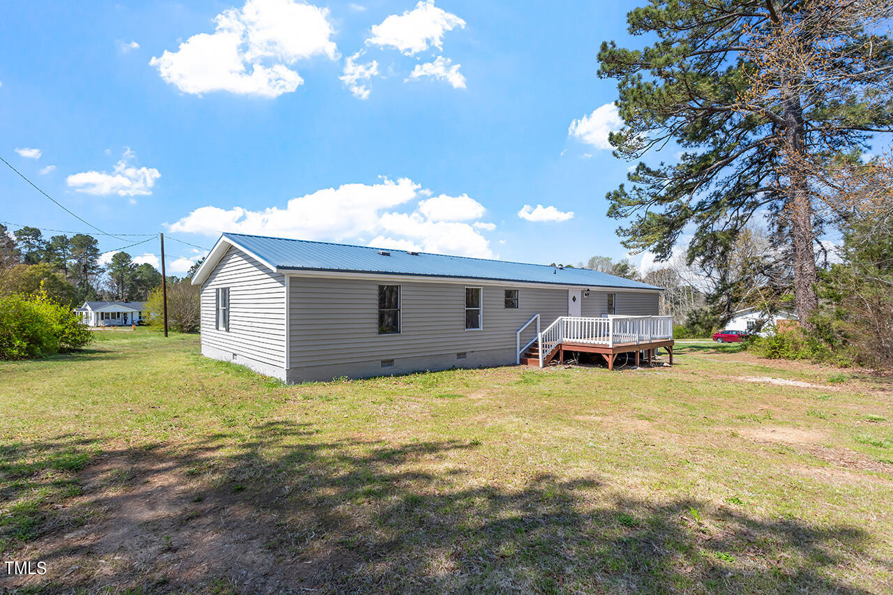 858 Foster Road Henderson, NC 27537 - Photo 36 of 38 a view of a house with a yard