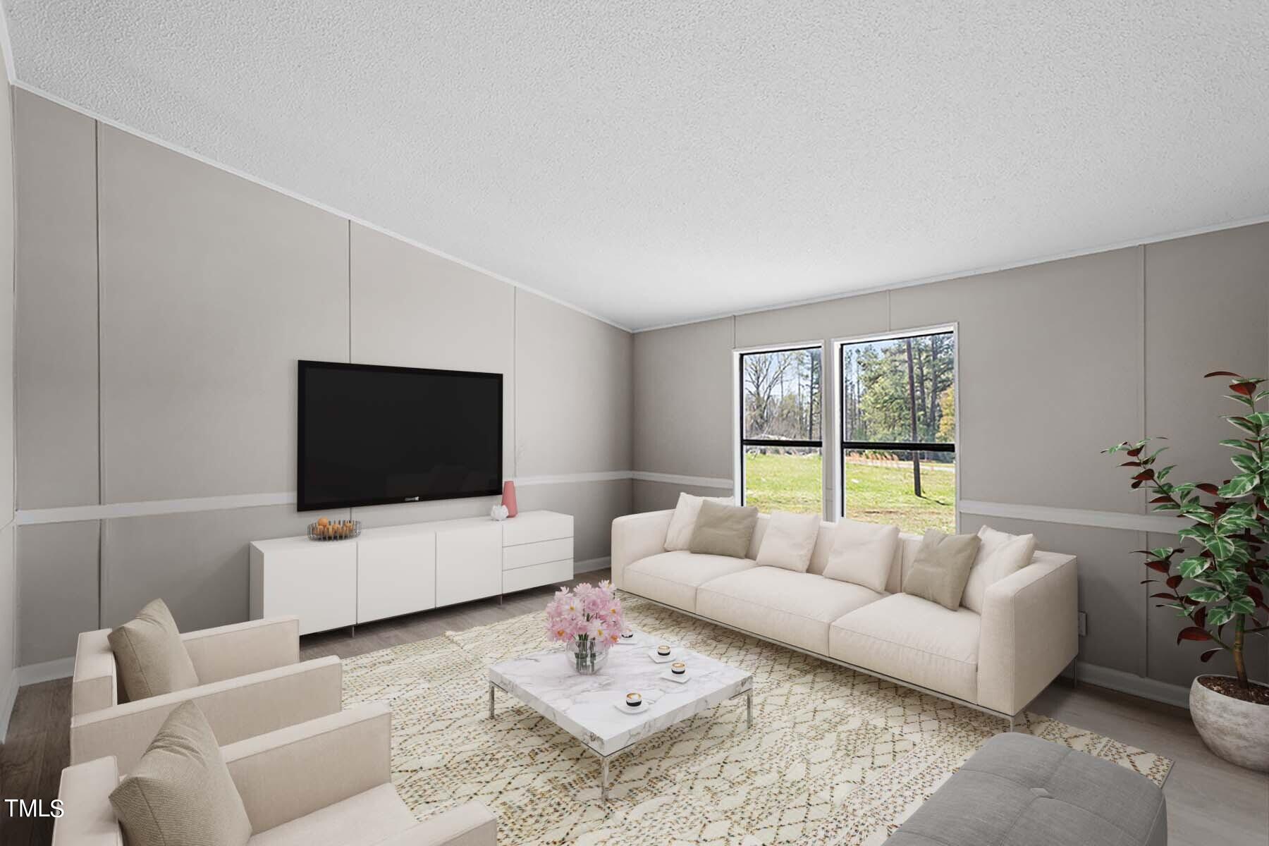 858 Foster Road Henderson, NC 27537 - Photo 5 of 38 a living room with furniture and a flat screen tv