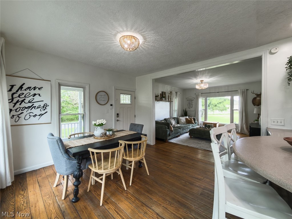 13429 West Calla Road Salem, OH 44460 - Photo 9 of 27 Spacious dining area featuring wood-finish flooring and a decorative chandelier