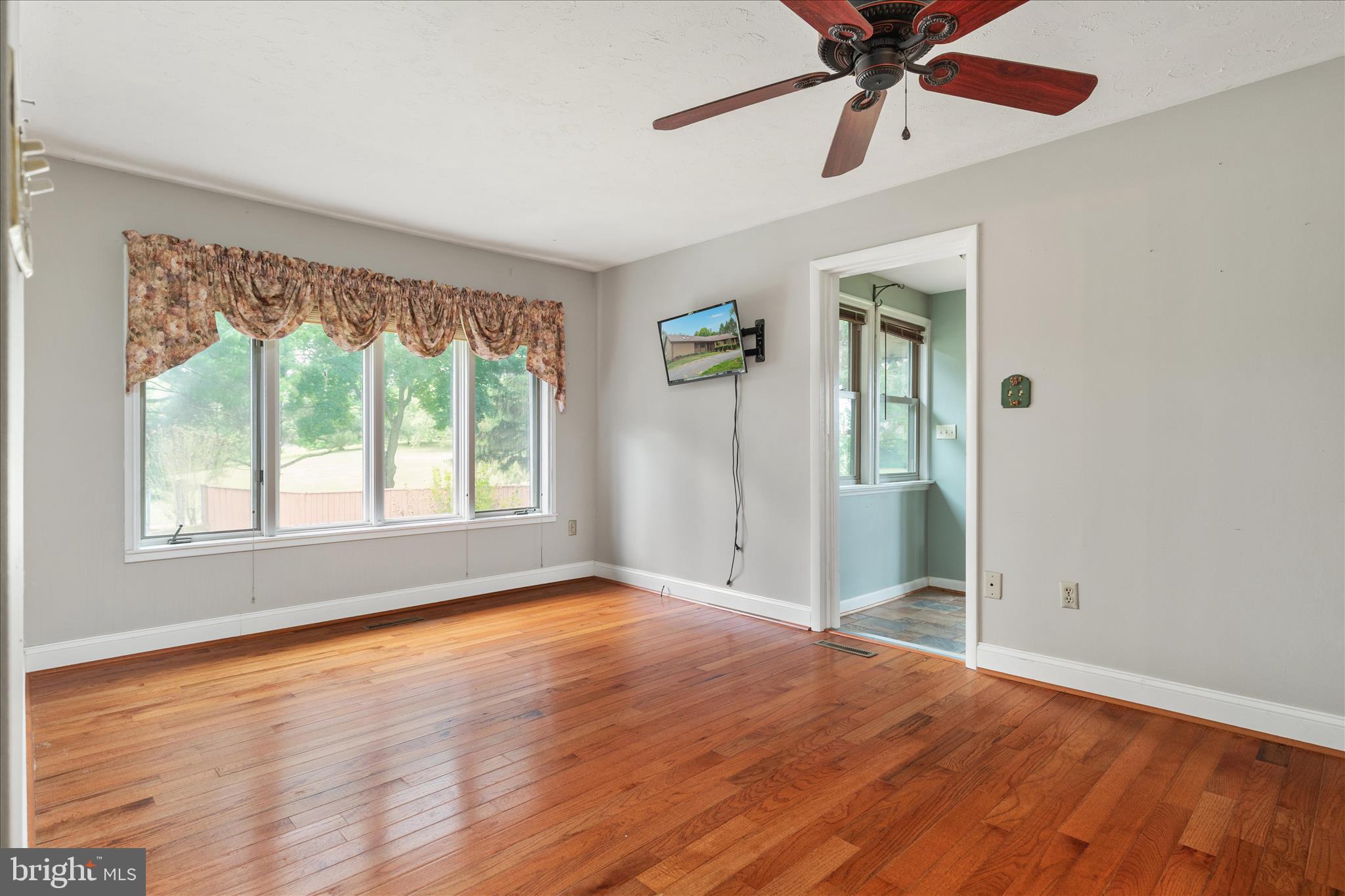 263 Bowling Green Road Front Royal, VA 22630 - Photo 5 of 75 a view of an empty room with window and wooden floor