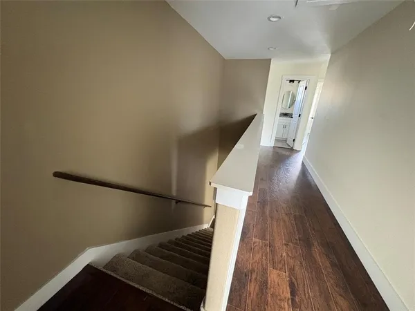 a view of entryway and hall with wooden floor
