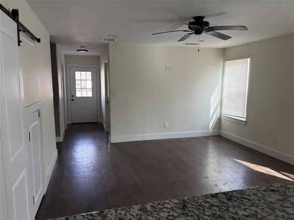 wooden floor in an empty room with a window