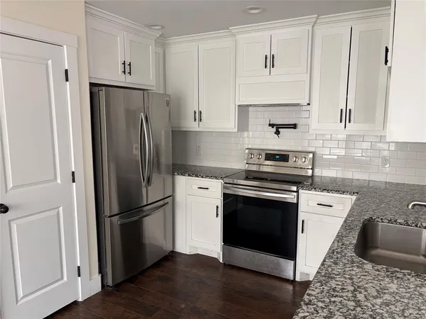 a kitchen with stainless steel appliances a refrigerator stove and sink