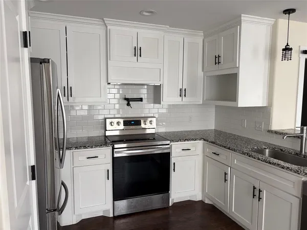 a kitchen with cabinets stainless steel appliances and a counter space