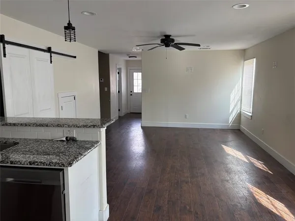a bathroom with a granite countertop sink and shower