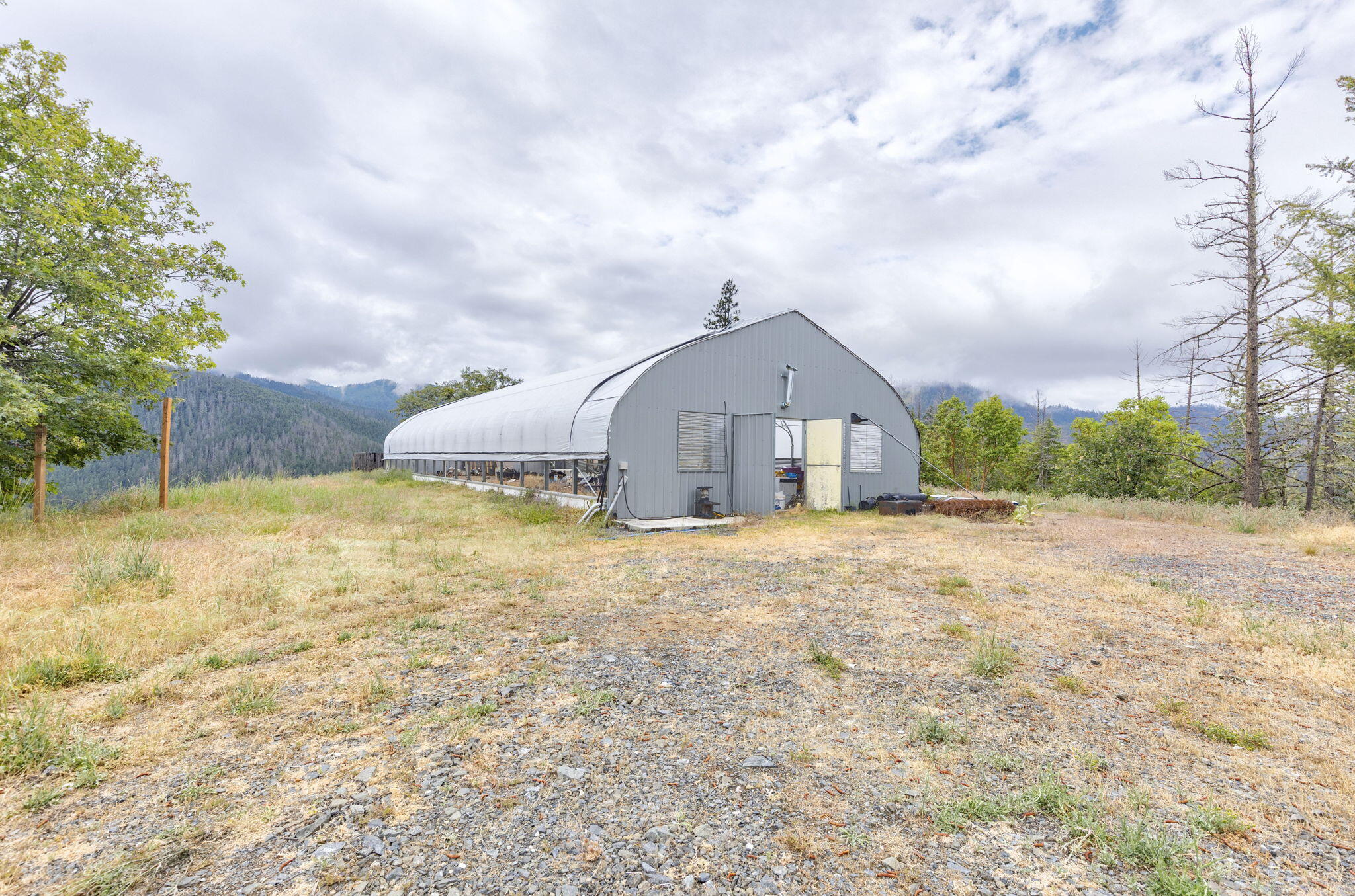 9595 Sterling Creek Road Jacksonville, OR 97530 - Photo 48 of 76 a front view of a house with a yard and garage