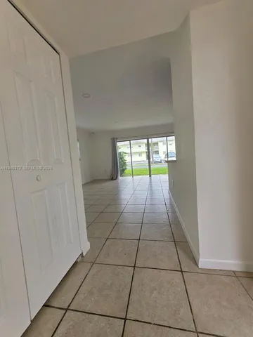 a view of an empty room with kitchen