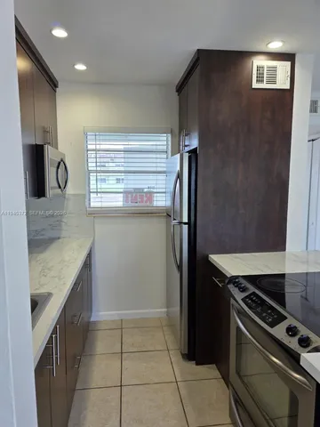 a kitchen with a refrigerator and a sink