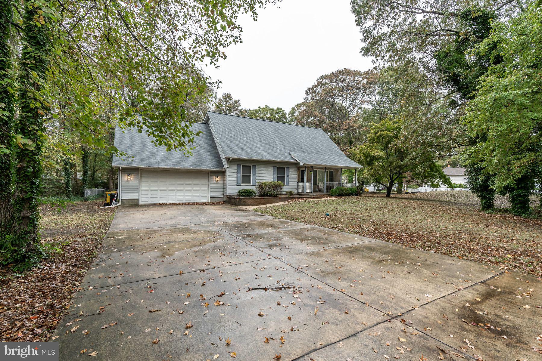 FRONT OF HOME WITH BIG DRIVE WAY.