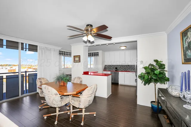 a view of a dining room with furniture and a potted plant