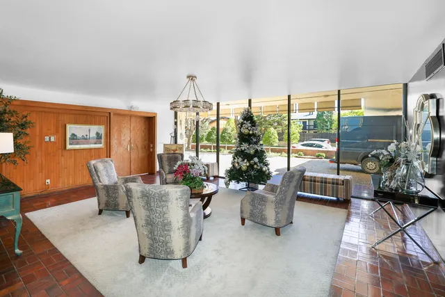 a living room with furniture and a floor to ceiling window