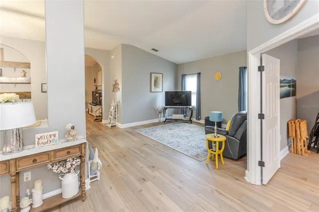 a living room with furniture dining table and a chandelier