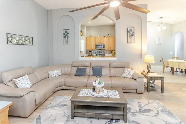 a large kitchen with stainless steel appliances a refrigerator a sink dishwasher a stove and white countertops with wooden floor