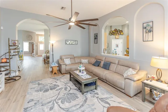 a kitchen with stainless steel appliances a refrigerator a sink and white cabinets