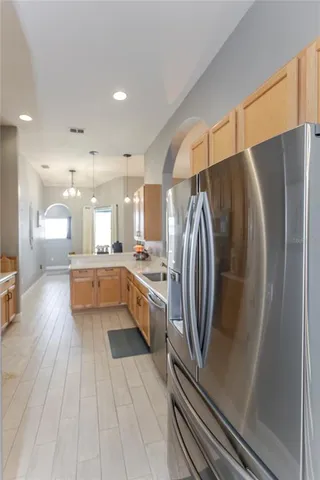 a bedroom with a bed a window and a chandelier