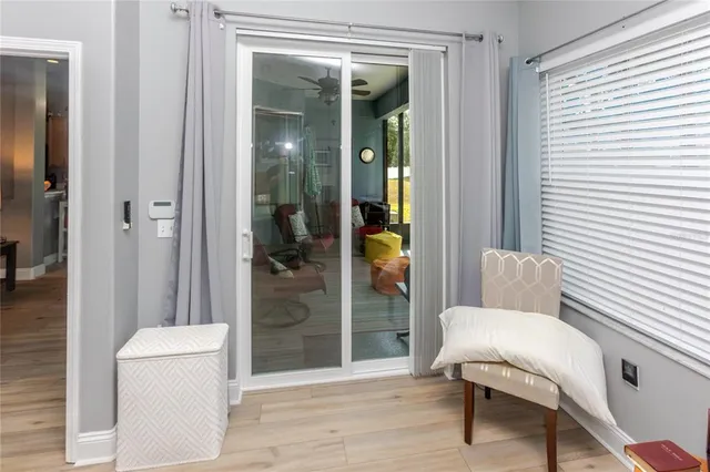 a view of a hallway with a livingroom and a livingroom with furniture