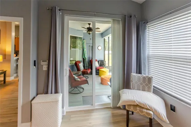 a view of a room that has a bed and a chandelier in it