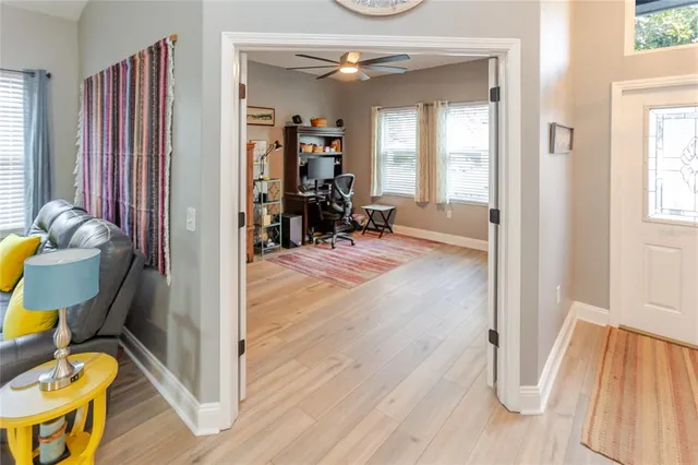 a view of a workspace with furniture and a window