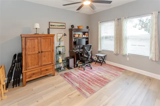 a view of a workspace with furniture and a window