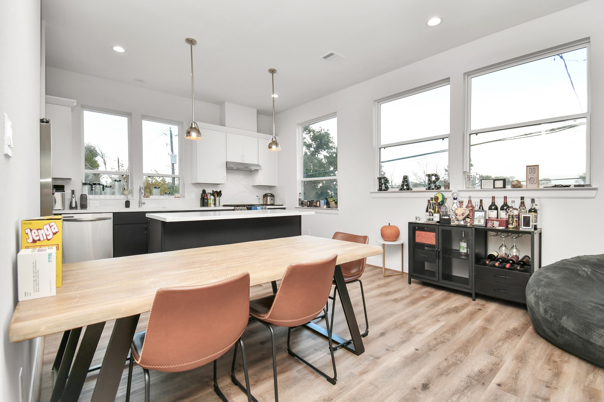 1905 Maury Street, Unit A Houston, TX 77026 - Photo 17 of 44 a dining area with stainless steel appliances kitchen island granite countertop a table chairs and a refrigerator