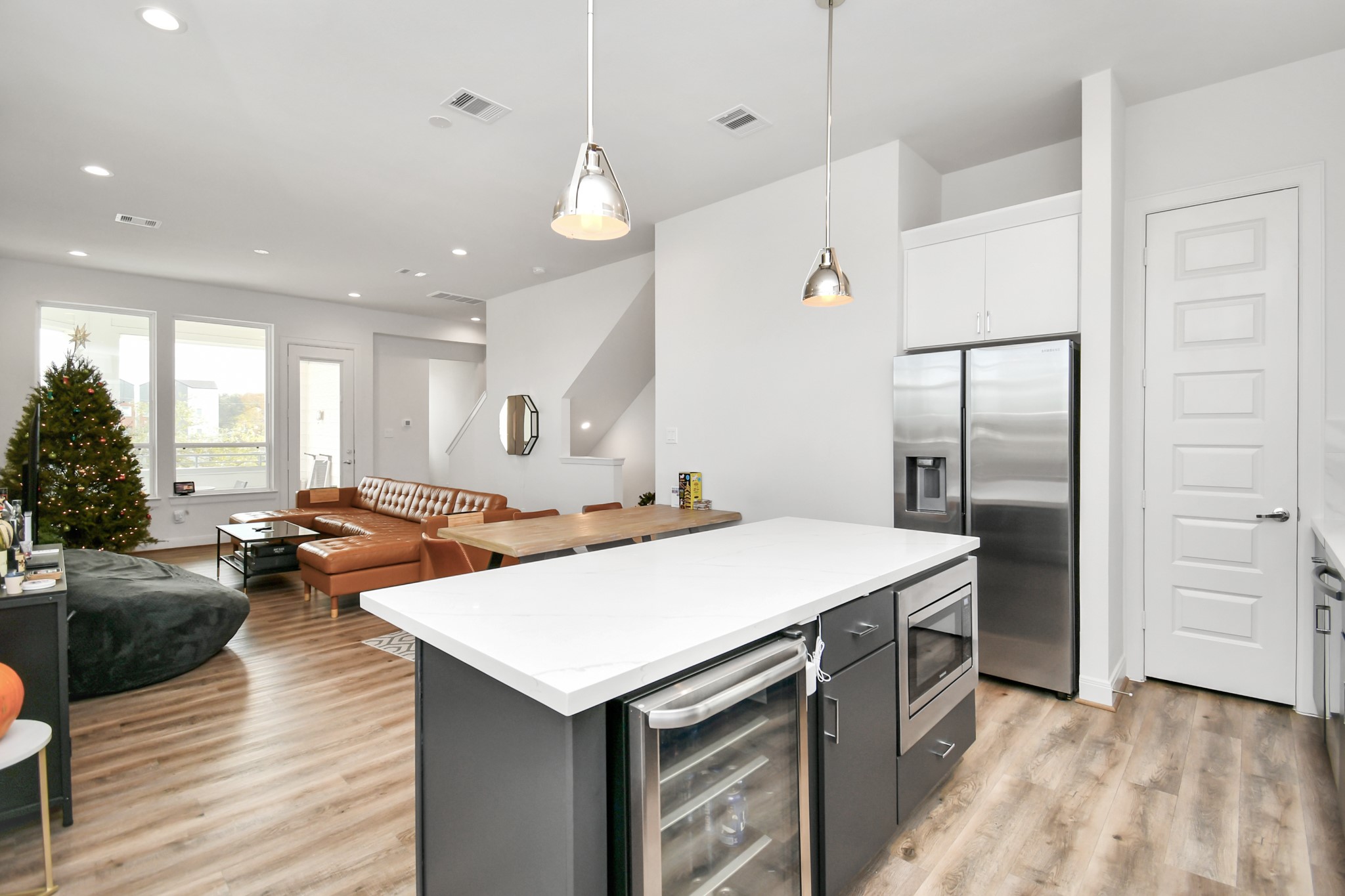 1905 Maury Street, Unit A Houston, TX 77026 - Photo 22 of 44 a kitchen with a refrigerator a sink and wooden floor