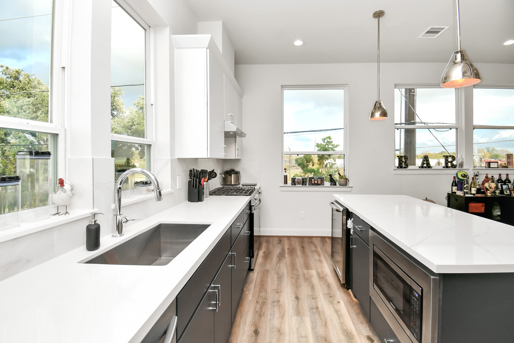 1905 Maury Street, Unit A Houston, TX 77026 - Photo 24 of 44 a kitchen with a stove a sink a center island and windows