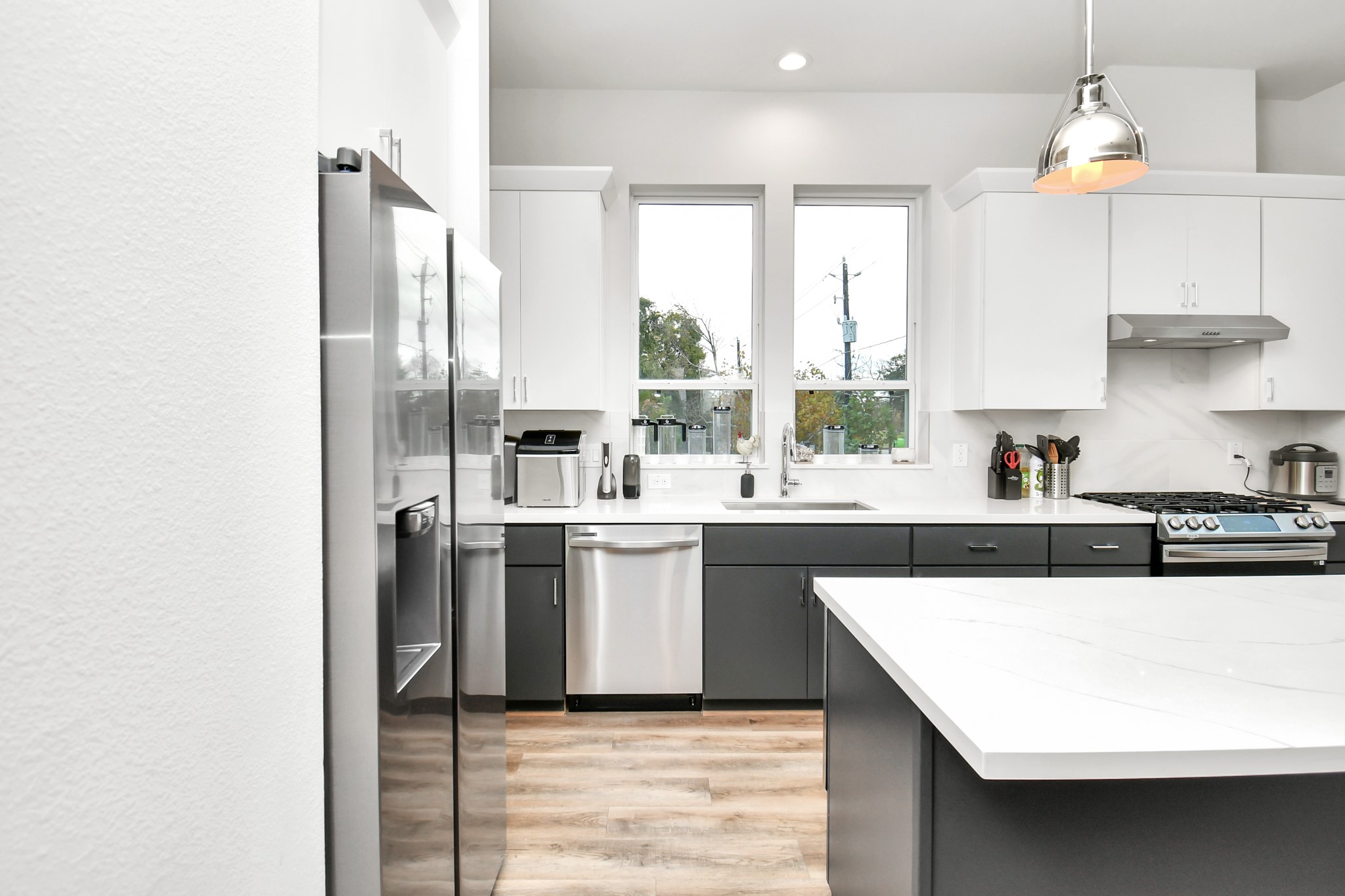 1905 Maury Street, Unit A Houston, TX 77026 - Photo 25 of 44 a kitchen with stainless steel appliances a sink a counter top space cabinets and a fireplace