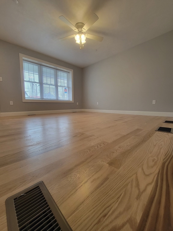55 Arlington Street, Unit 7 Brockton, MA 02301 - Photo 1 of 37 a view of a room with wooden floor and fan