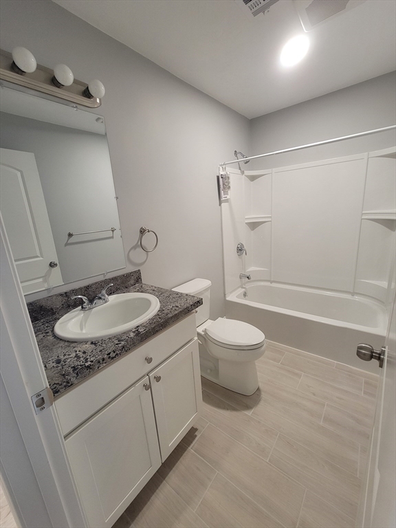 55 Arlington Street, Unit 7 Brockton, MA 02301 - Photo 16 of 37 a bathroom with a granite countertop sink toilet and shower