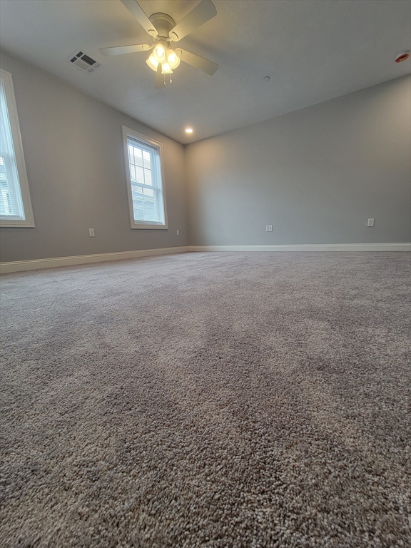 55 Arlington Street, Unit 7 Brockton, MA 02301 - Photo 24 of 37 an empty room with windows and fan