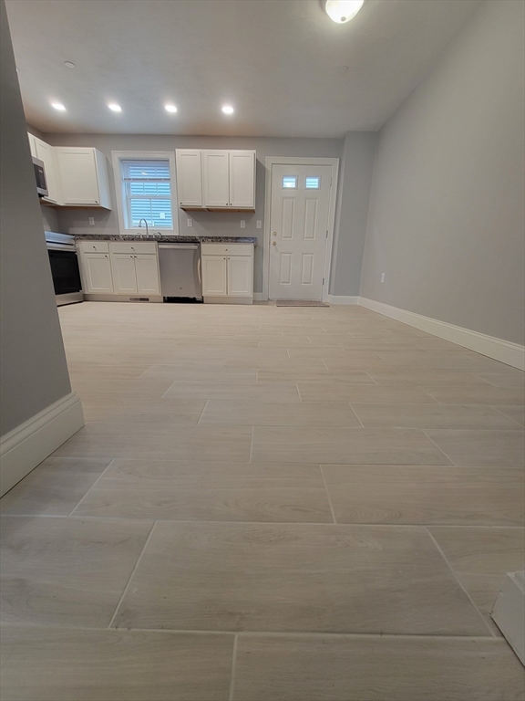 55 Arlington Street, Unit 7 Brockton, MA 02301 - Photo 4 of 37 a view of kitchen with kitchen island and stainless steel appliances