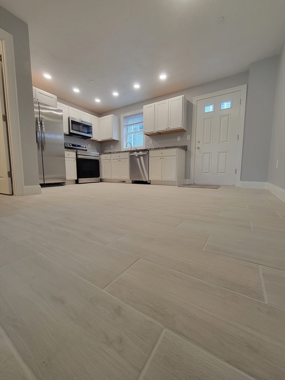 55 Arlington Street, Unit 7 Brockton, MA 02301 - Photo 5 of 37 a view of kitchen with refrigerator and kitchen island