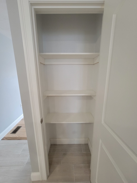55 Arlington Street, Unit 7 Brockton, MA 02301 - Photo 9 of 37 a view of walk in closet with empty racks