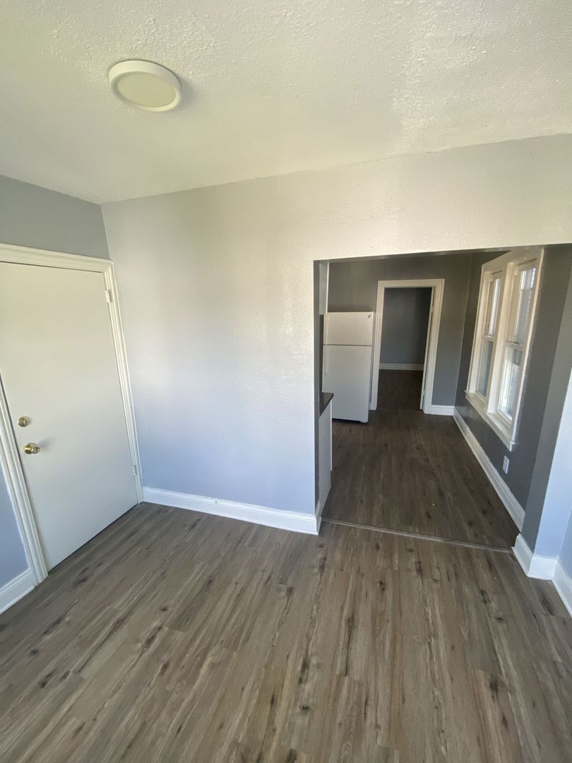 4812 South Elizabeth Street, Unit 2R Chicago, IL 60609 - Photo 3 of 14 a view of a livingroom with wooden floor and staircase