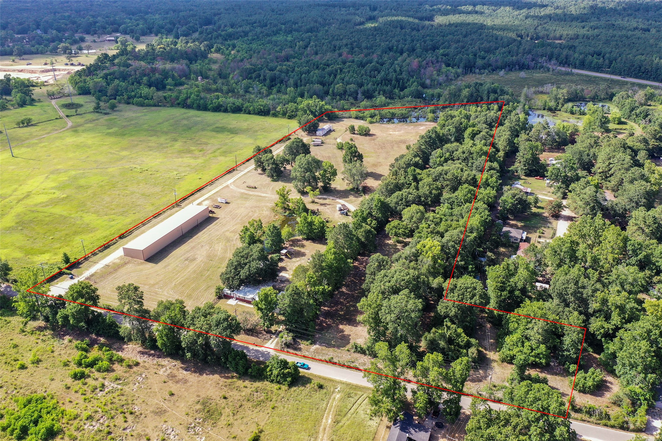 14985 Wiggins Road Conroe, TX 77302 - Photo 1 of 50 This is the entire property which is 10 acres, 2 homes, and 2 ponds. The 5 acres that is for sale is where the double-wide is going to back pond including the middle pond.