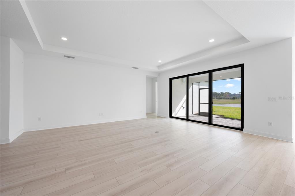 5770 Freestone Circle Apollo Beach, FL 33572 - Photo 13 of 29 a view of an empty room with wooden floor and a window