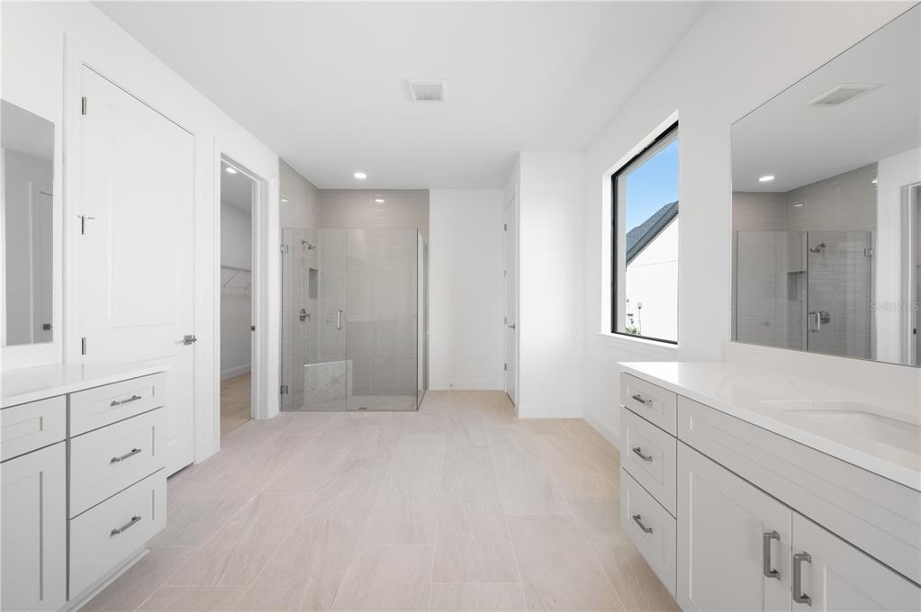 5770 Freestone Circle Apollo Beach, FL 33572 - Photo 18 of 29 a bathroom with a sink a mirror and a shower