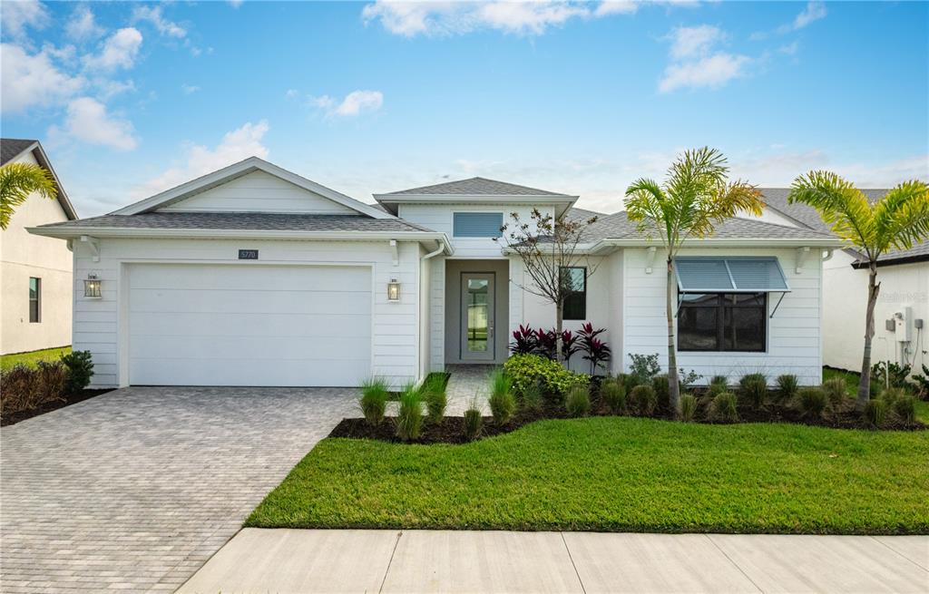 5770 Freestone Circle Apollo Beach, FL 33572 - Photo 28 of 29 a front view of a house with a garden and plants