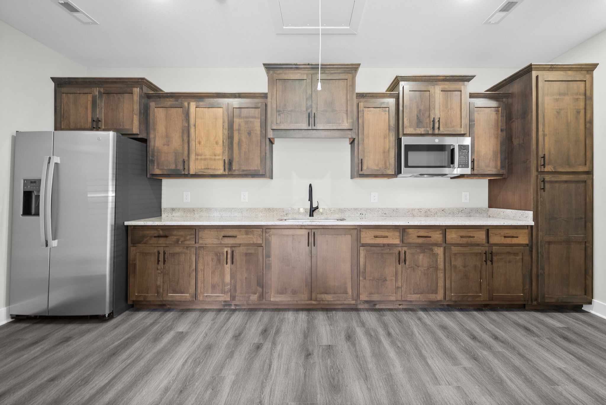 2510 Pea Ridge Road Clarksville, TN 37040 - Photo 25 of 40 a kitchen with granite countertop a refrigerator a sink and wooden cabinets