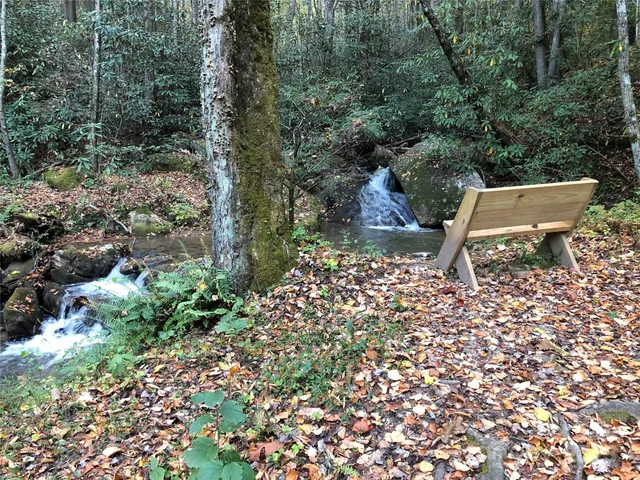 a view of a lake with chairs and table