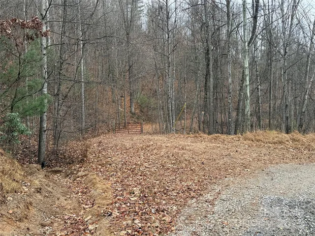 a wooden fence with trees in the background