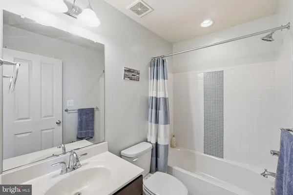 a bathroom with a sink toilet tub and shower